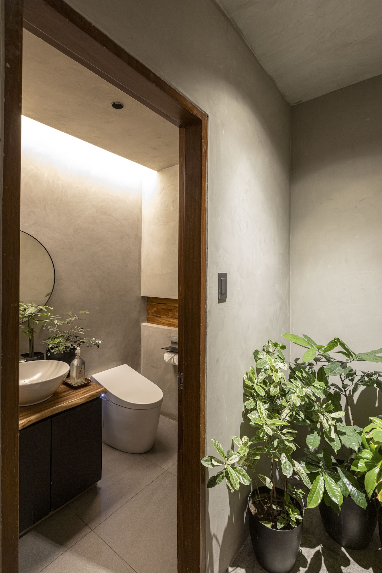 What's inside the Toyo Eatery powder room is hardly taboo—ample light, concrete finishing, a Japanese toilet, and plenty of plants