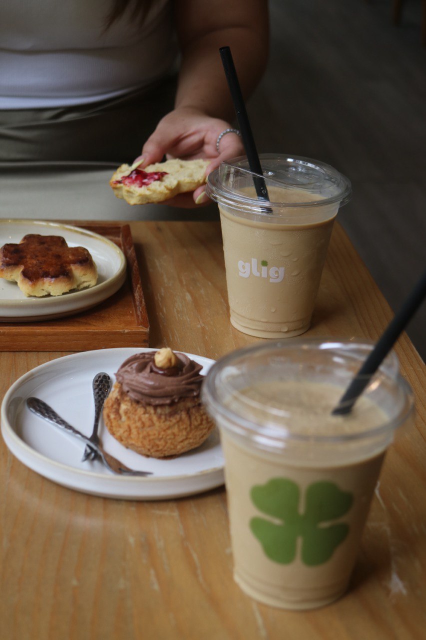 An ice-blended milk slushie topped with espresso paired with a four-leaf clover-shaped scone