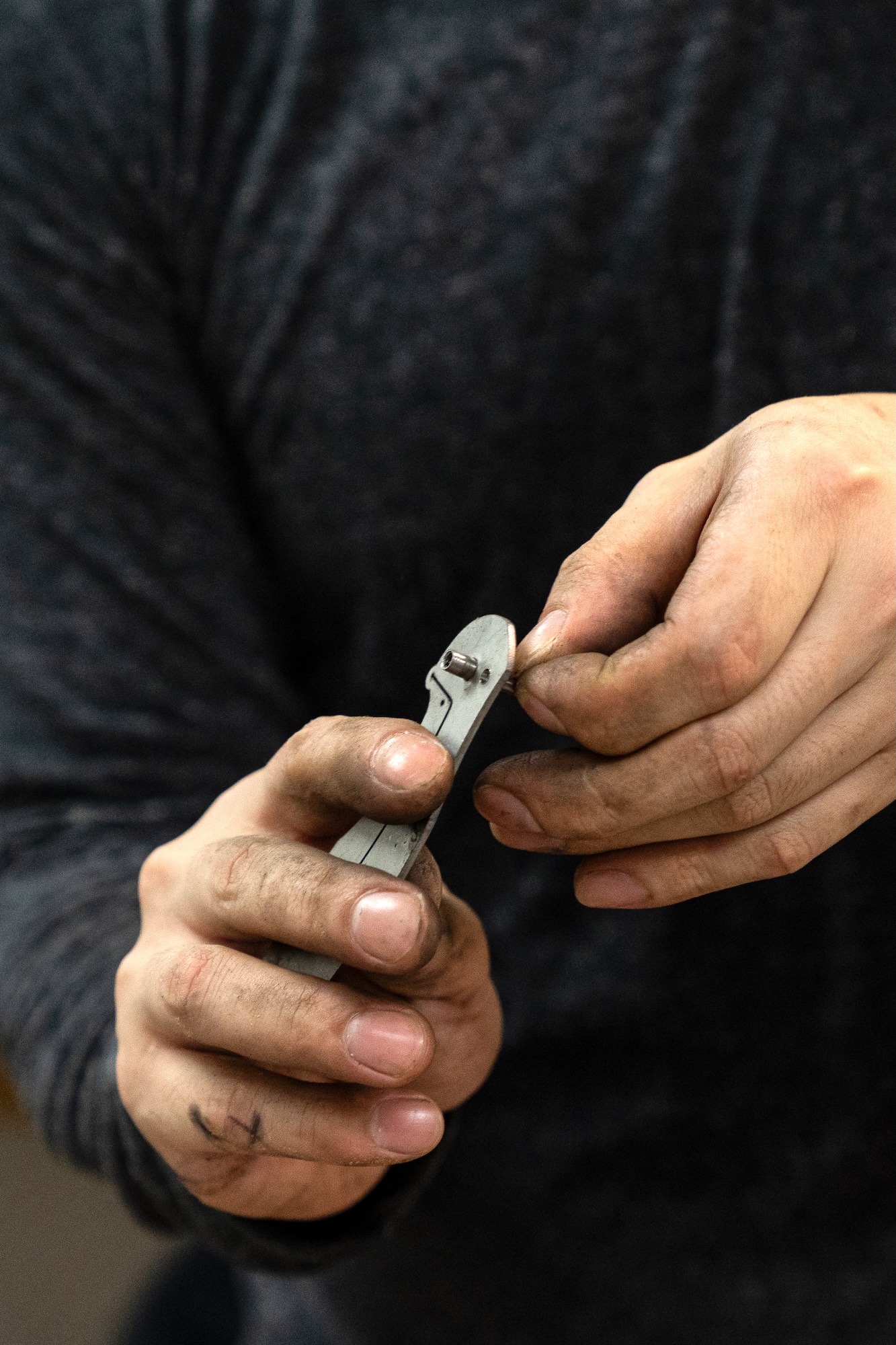 Balete Blades: Sean Alonzo holds a folding knife handle liner with a pivot barrel and a stop pin