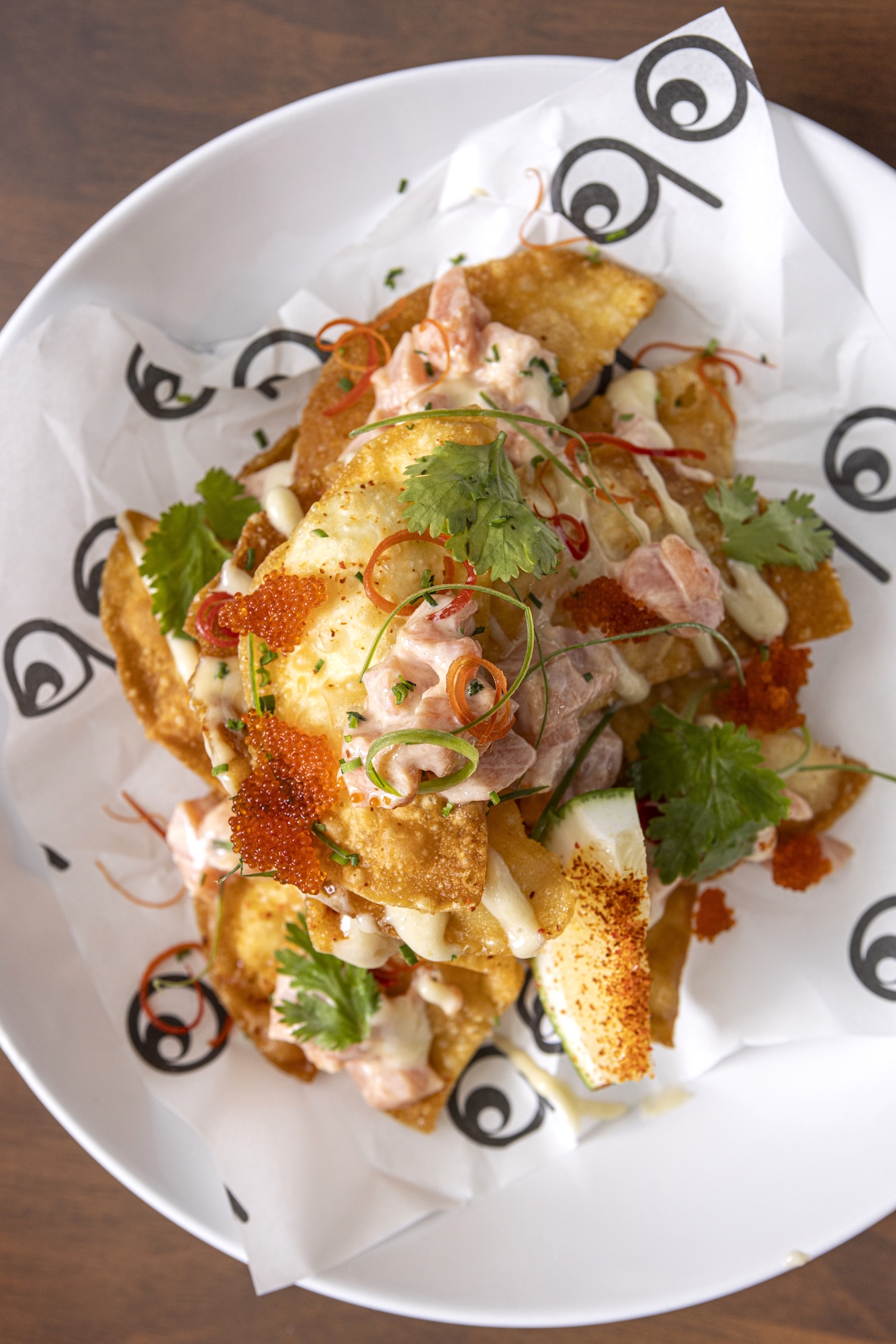 Salmon tartare nachos (salmon, lime creme fraiche, yuzu dressing, wasabi mayo, tobiko)