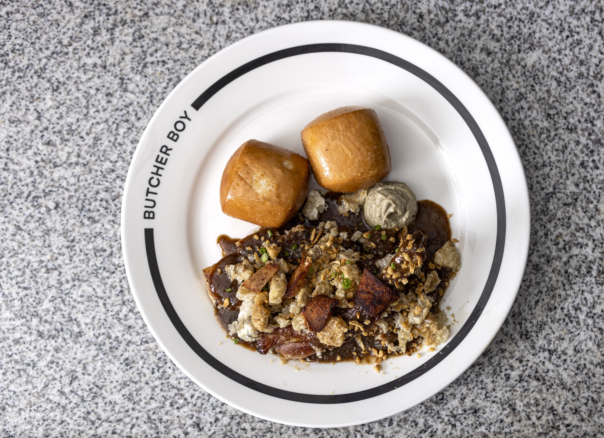 Sticky pork adobo bao (glazed pork adobo, mantou, chicken liver parfait, garlic chicharon crumbs)