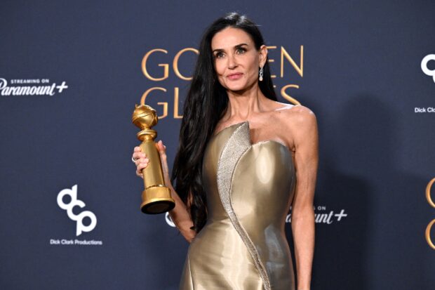 US actress Demi Moore poses with the Best Performance by a Female Actor in a Motion Picture ñ Musical or Comedy award for "The Substance" in the press room during the 82nd annual Golden Globe Awards at the Beverly Hilton hotel in Beverly Hills, California, on January 5, 2025. (Photo by Robyn Beck / AFP)