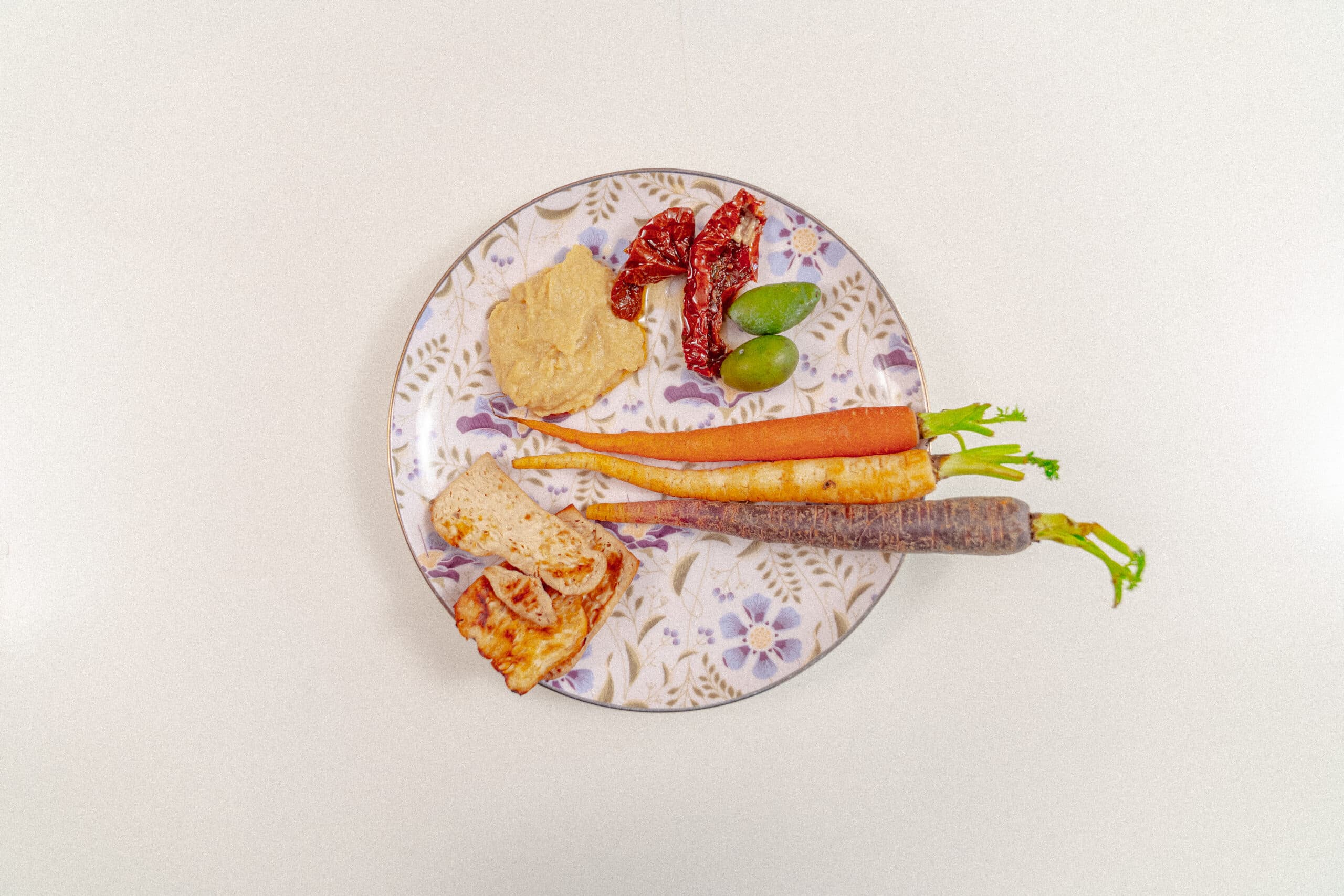 Olives, sun-dried tomatoes, carrots, hummus, baked tofu