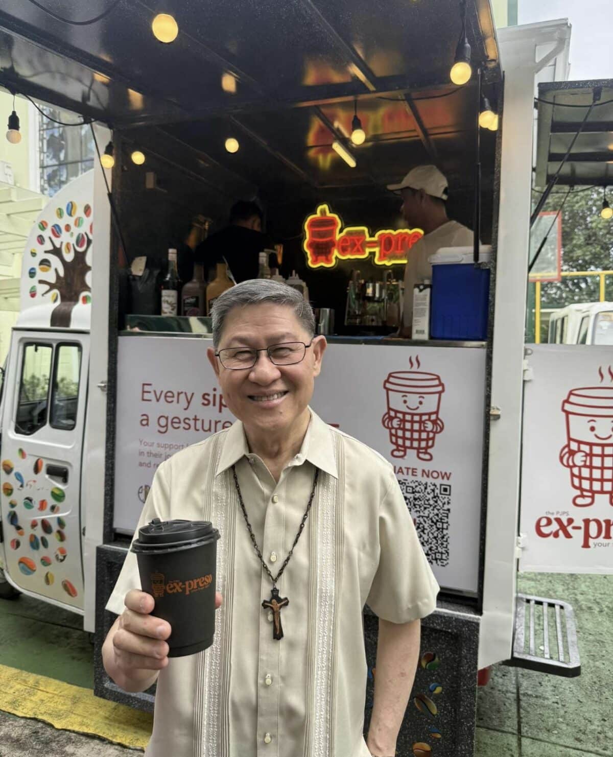 Cardinal Tagle with a cup of Ex-Preso coffee