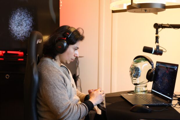 A representation of brain focus as a pattern of dots is displayed by the Prime application as Neurable CEO Ramses Alcaide demonstrates Neurable and HP Inc.ís HyperX collaboration brain-computer interface and gaming audio headset for neurofeedback to measure brainwave activity (EEG) and improve brain function during the annual Consumer Electronics Show (CES) in Las Vegas, Nevada on January 7, 2026. Beyond smart watches and rings, artificial intelligence is being used to make self-testing for major diseases more readily available, from headphones that detect early signs of Alzheimer's to an iris-scanning app that helps spot cancer. (Photo by Patrick T. Fallon / AFP)