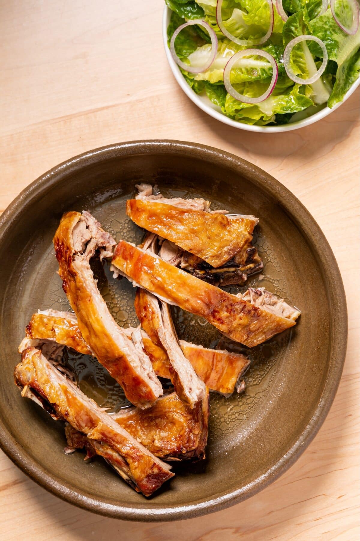 Alfonso Roasting Room's lechazo with a side of greens from their farm