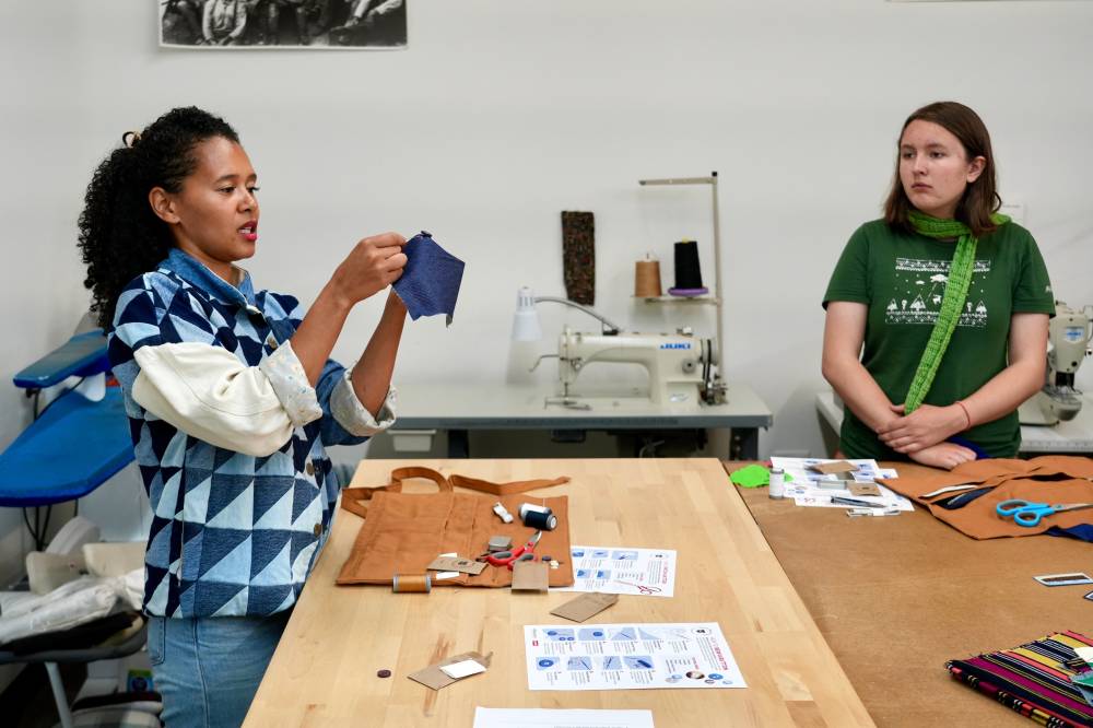 Levi’s employees Ella Fasslet Clausen teaches during a sewing workshop